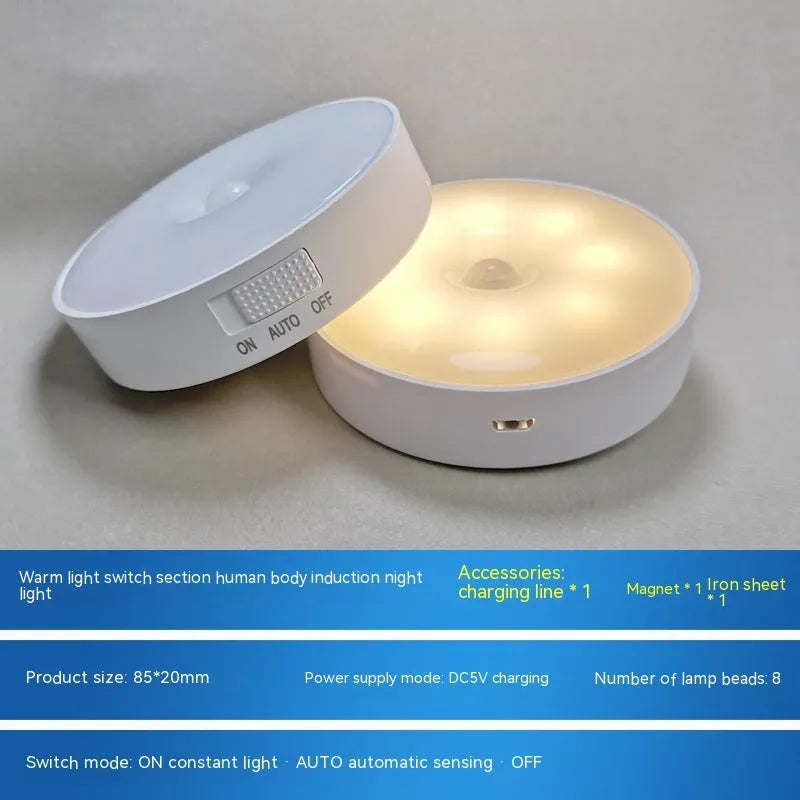 Compact round white LED motion sensor night light with USB charging cable and adhesive tape
