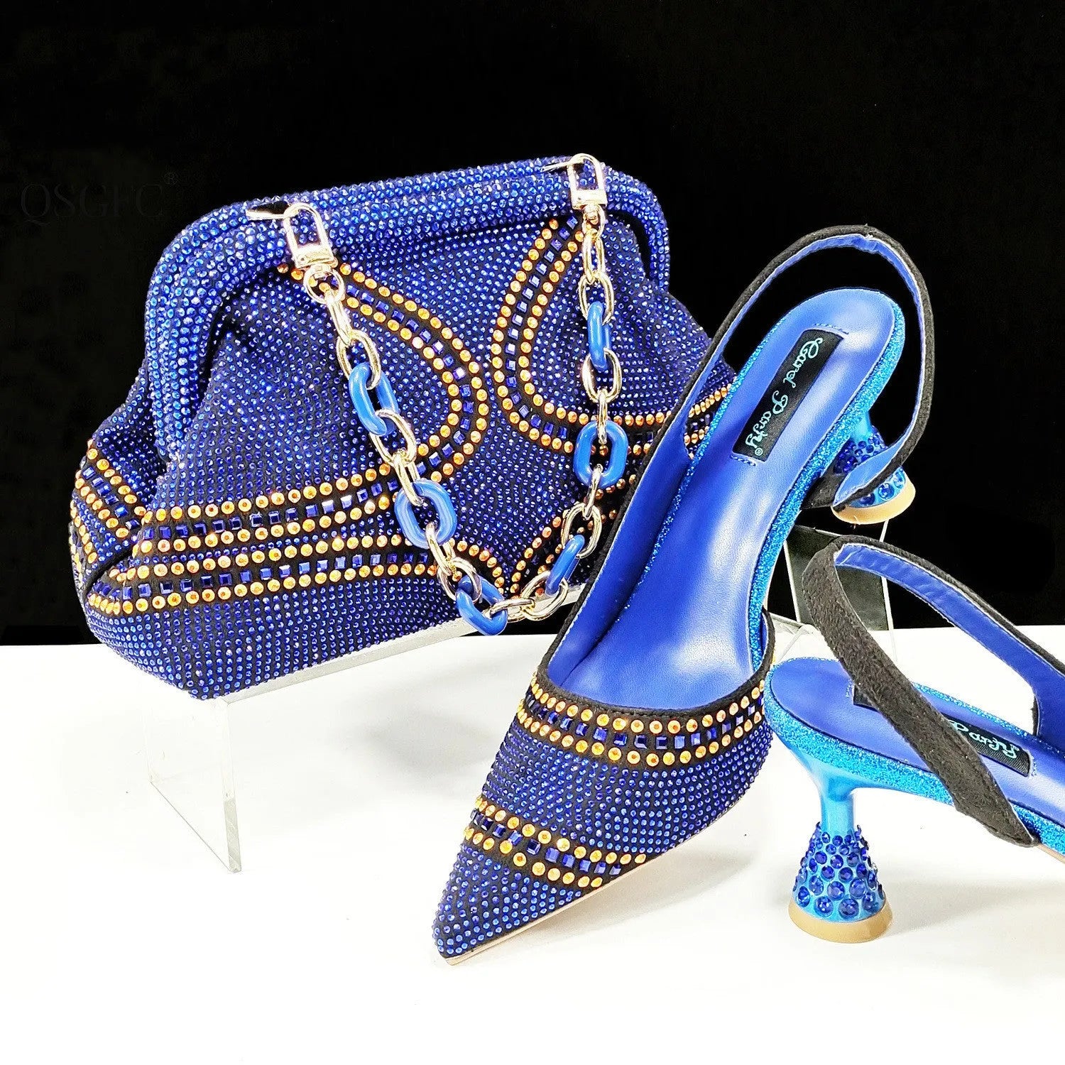 Women's pointed-toe high heel shoes with matching bag, featuring a stiletto heel and rhinestone detail on a synthetic leather upper.