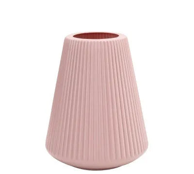 Melamine plastic flower vase in blue colour on desktop with white flowers