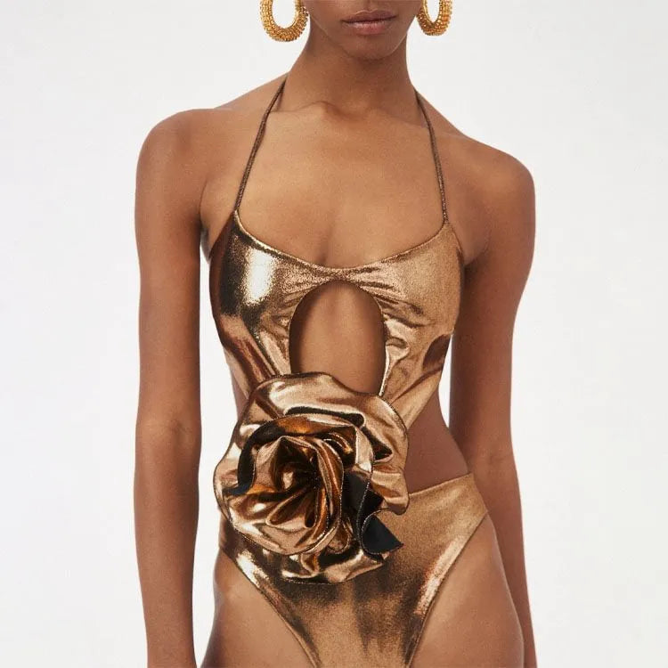Gold coloured one-piece swimsuit with halter neckline on a model.