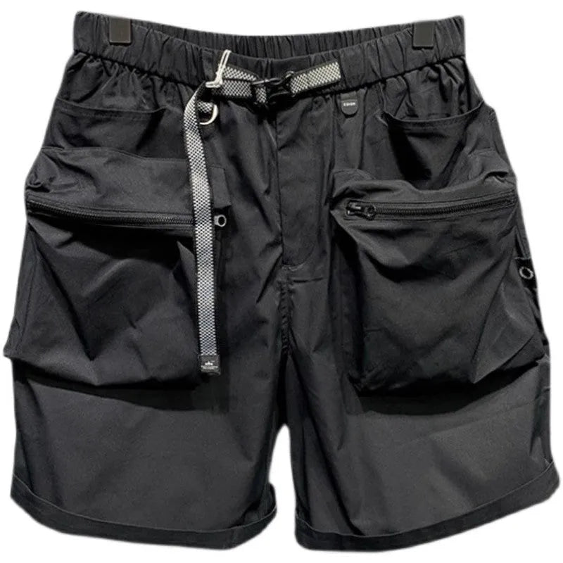 Man wearing large size black loose-fit work shorts with pockets, showing above-the-knee length.