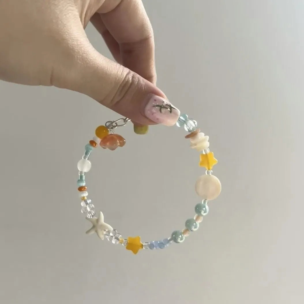 Orange mixed-alloy bracelet with diamond pattern and water-soaked bead seaside design