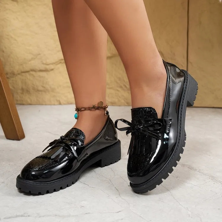 Brown women's loafer with a bow detail on the vamp, made from artificial PU leather.