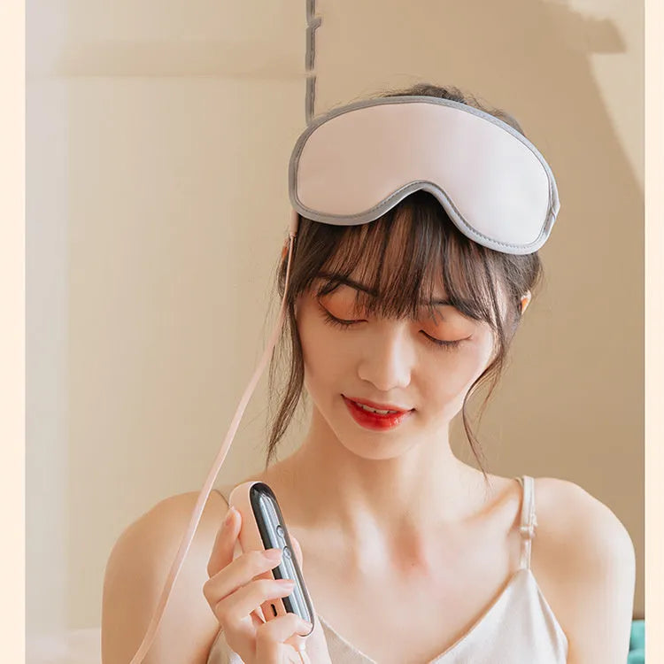 Pink or green portable eye SPA massage goggles on a grey background