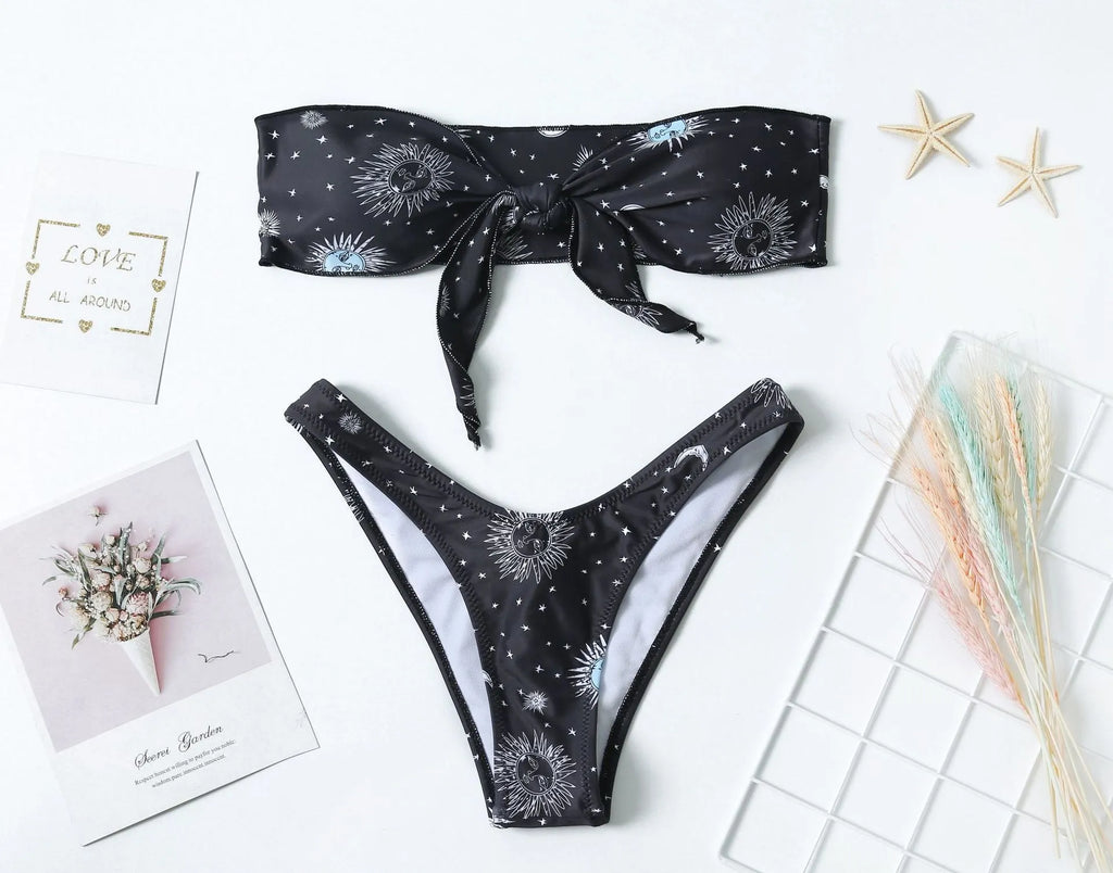 Black one-piece swimsuit with bikini print, split tube top, and backless design for women.
