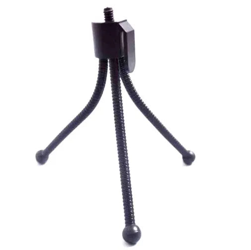 Small silver aluminium desktop tripod with ball head, shown collapsed next to an Apple iPhone for scale