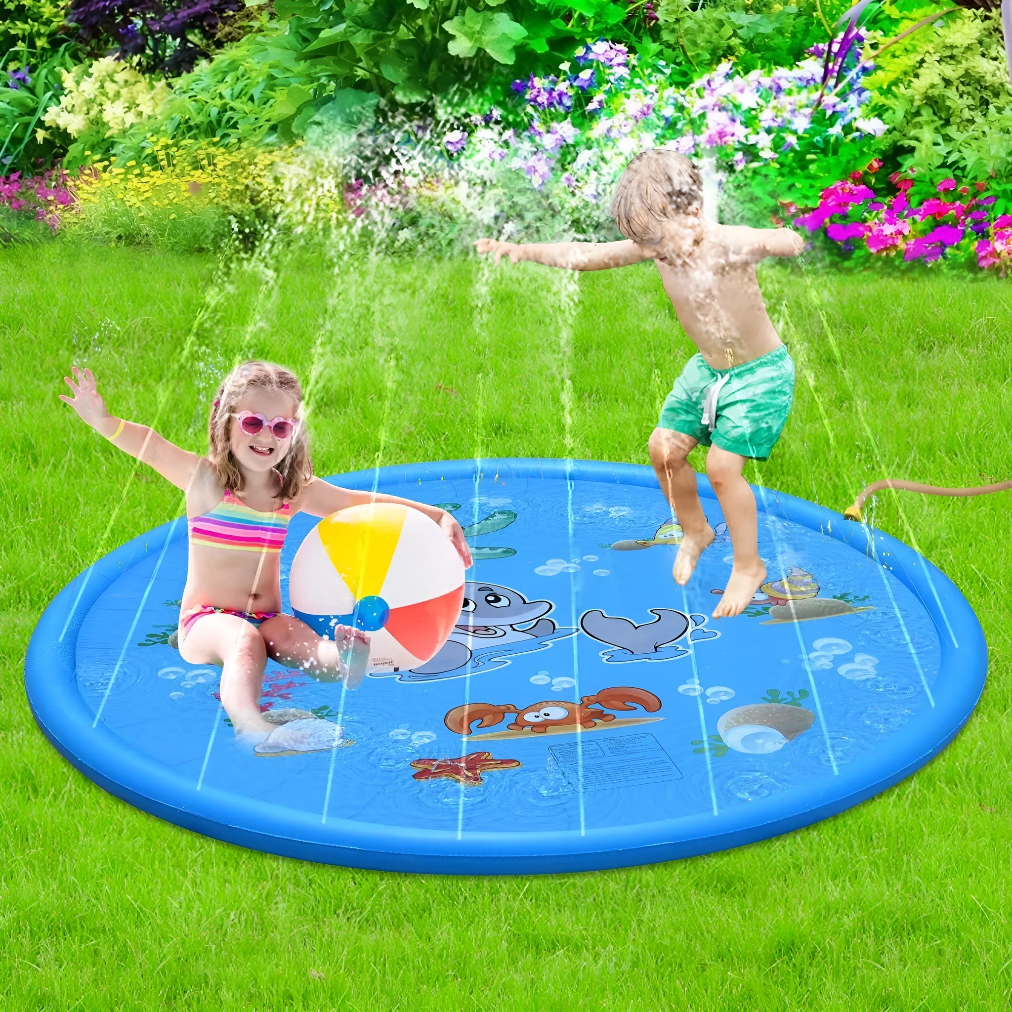 Blue PVC children's water spray mat with marine animal designs laid on grass, connected to a garden hose.