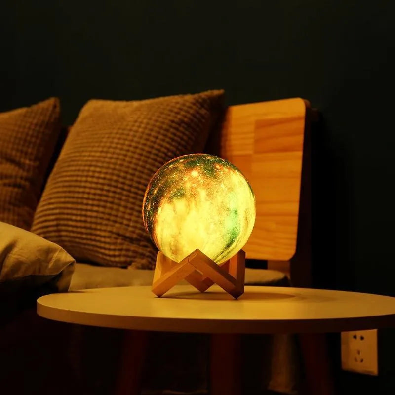 3D printed white lunar night light with colour-changing LED sphere on a stand, showing remote control.