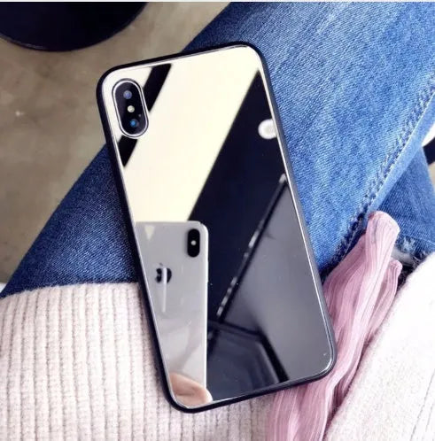 Black iPhone mirror phone case showing reflective glass back, compatible with multiple iPhone models.