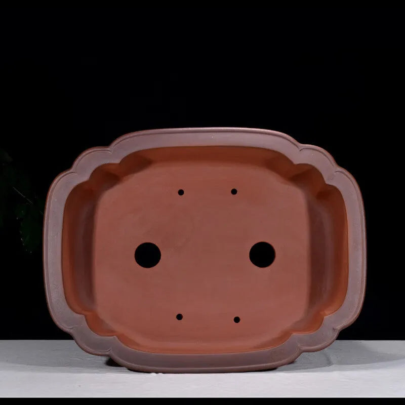 Large antique-finish Chinese purple clay flowerpot shaped like a tree stump with decorative carvings.