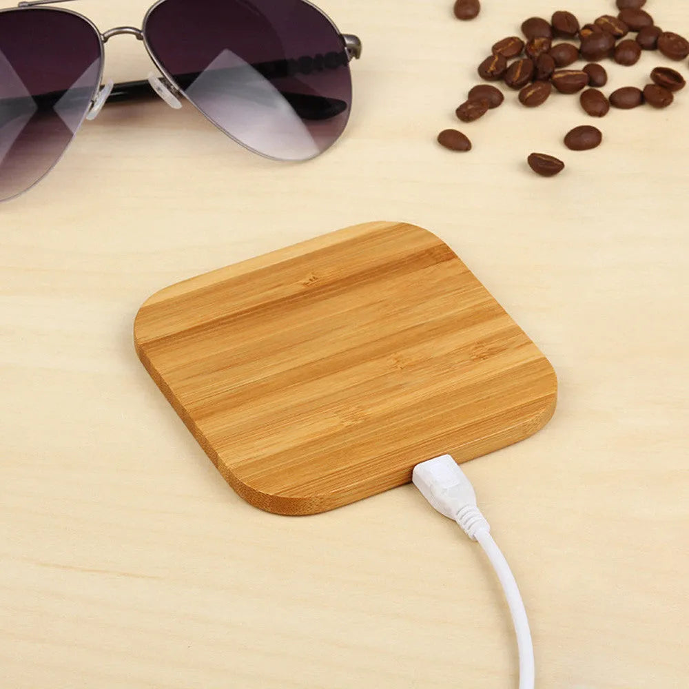 Square bamboo 5W wireless charging pad on a wooden table