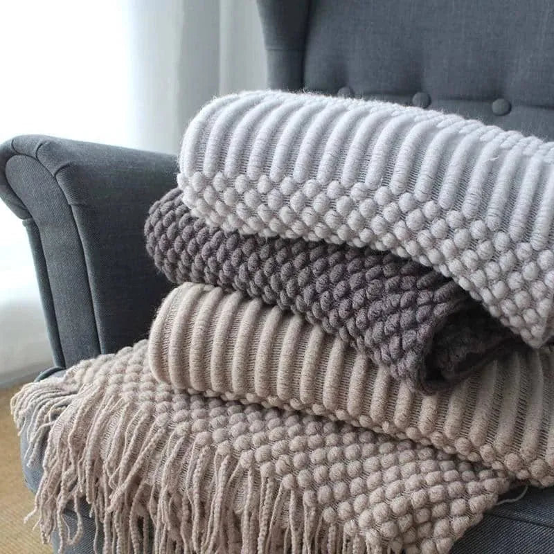 Small dark grey polyester nap blanket folded, showing its size of 127 cm by 170 cm.