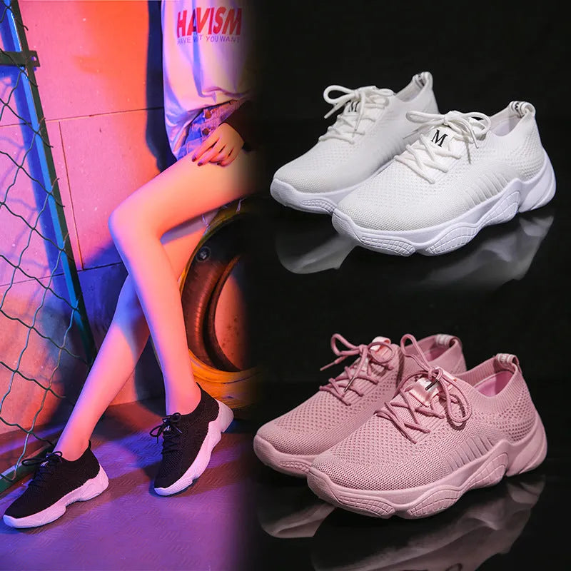 Women's white sports shoes with thick rubber soles and woven upper featuring lace-up front strap