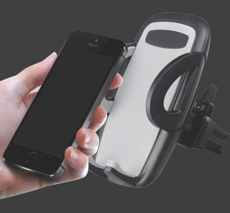 Black plastic mobile phone holder mounted on car air conditioning outlet with phone inserted