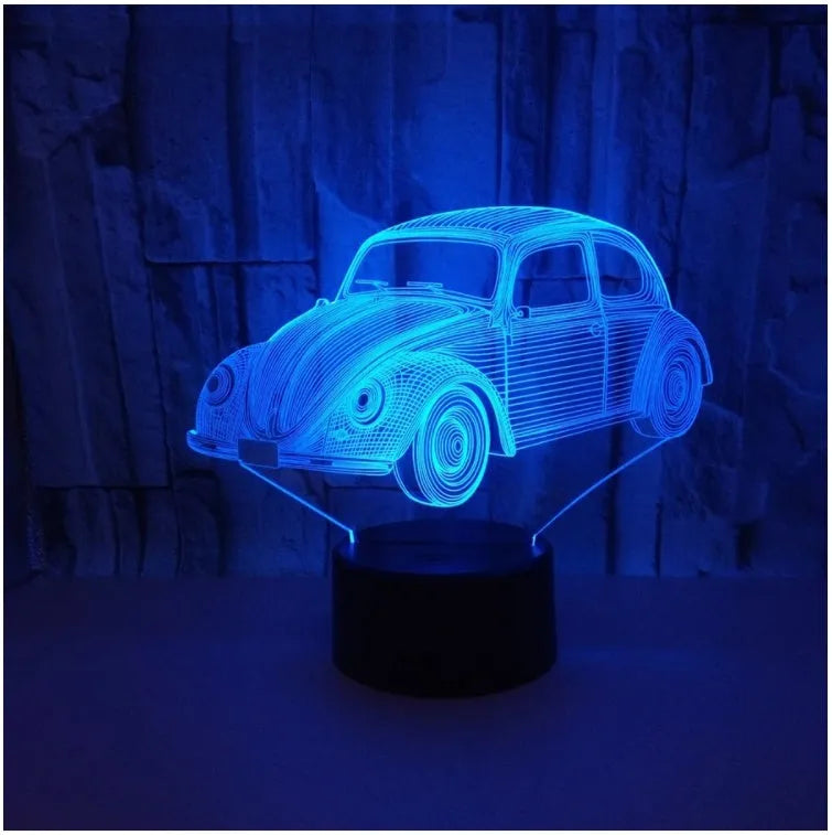 Colourful 3D LED desk lamp with black base and acrylic shade on wooden desk