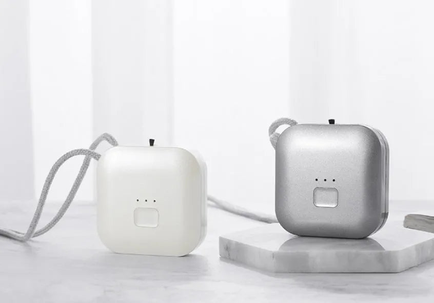 Mini USB air purifier necklace in pink showing compact wearable design with one-button control