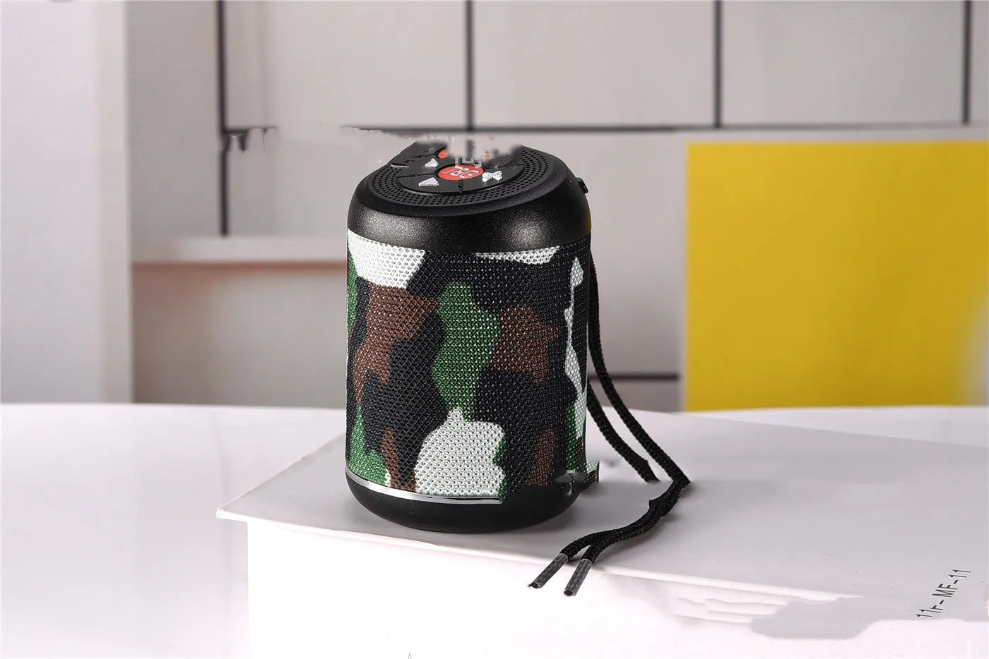 Portable outdoor Bluetooth subwoofer speaker in multiple colour options including black, blue, and camouflage.