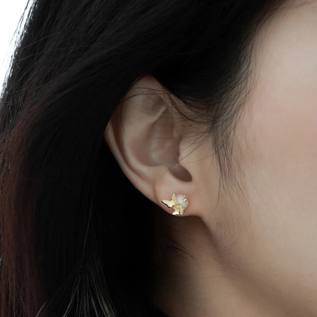 A pair of 925 silver stud earrings with an original butterfly and animal design in a gold colour finish.