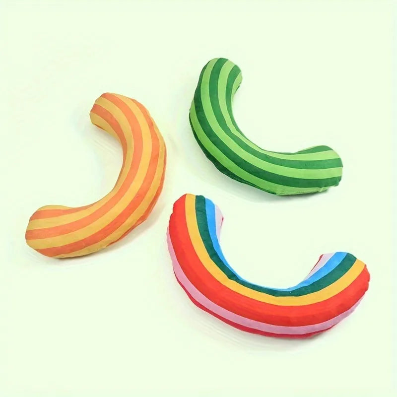 Green, rainbow, and yellow cat toy set with noise-maker, catnip, and a striped pillow measuring 23 by 20 cm.