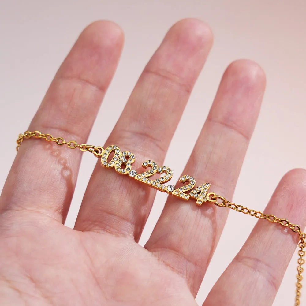 Stainless steel digital bracelet with diamond-set numbers in gold, rose gold, or steel colour.