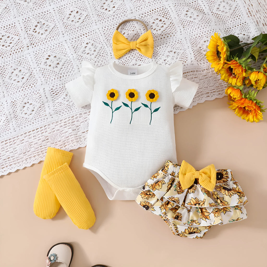 Baby girl yellow triangle ruffled shorts suit with white blouse and bow detail on baby model