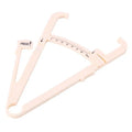 White acrylic body fat caliper with measurement scale for skinfold thickness testing.