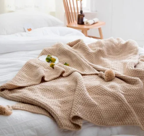 Nordic fringed knit ball acrylic blanket in beige colour showing texture detail and 130x170cm size