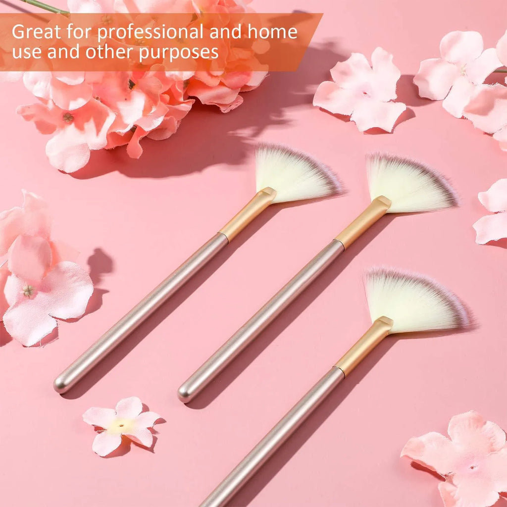 Ten champagne-coloured facial fan brushes with acrylic handles and protective covers laid out.