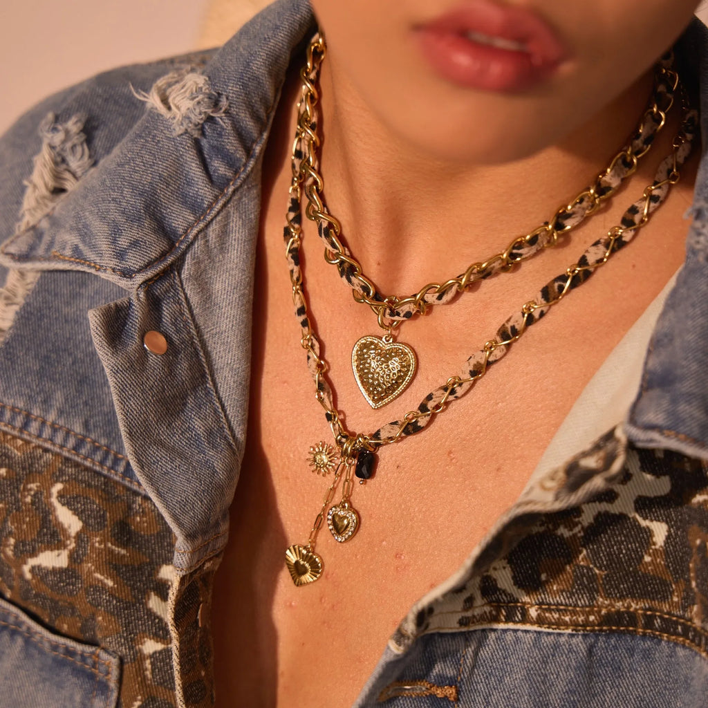 Gold-plated stainless steel necklace with leopard and love geometric pendant on an adjustable chain.
