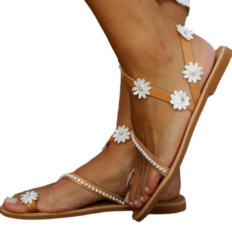 Brown Roman sandals with floral decoration and flat rubber soles