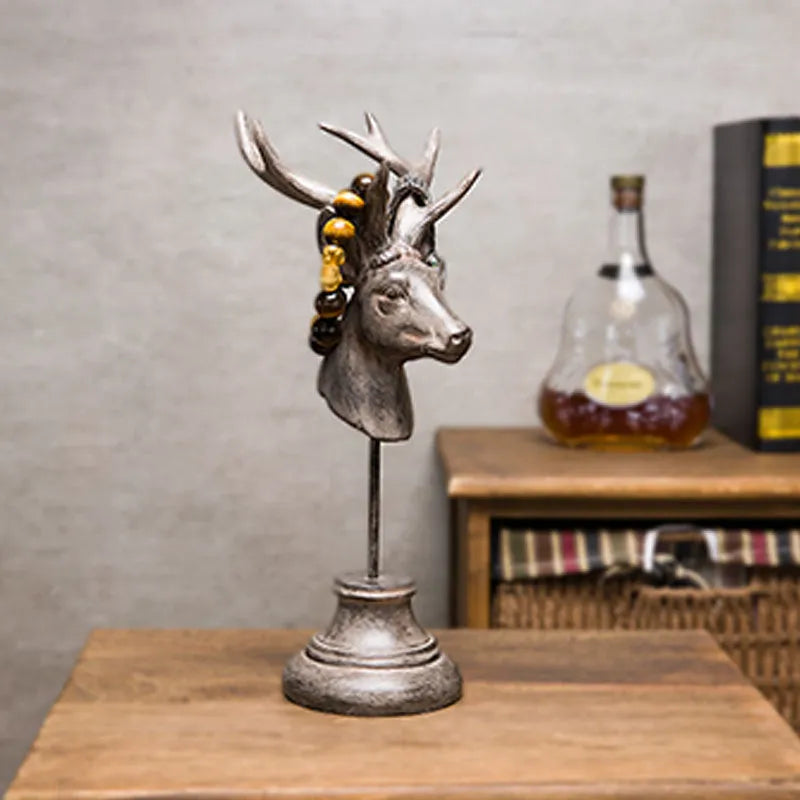 Tall black natural resin animal sculpture for home decoration on a wooden table.
