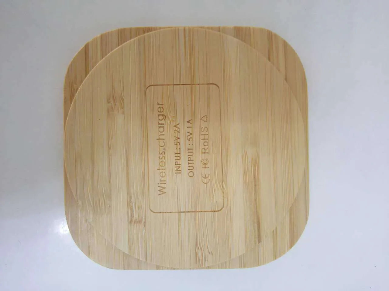Square bamboo 5W wireless charging pad on a wooden table