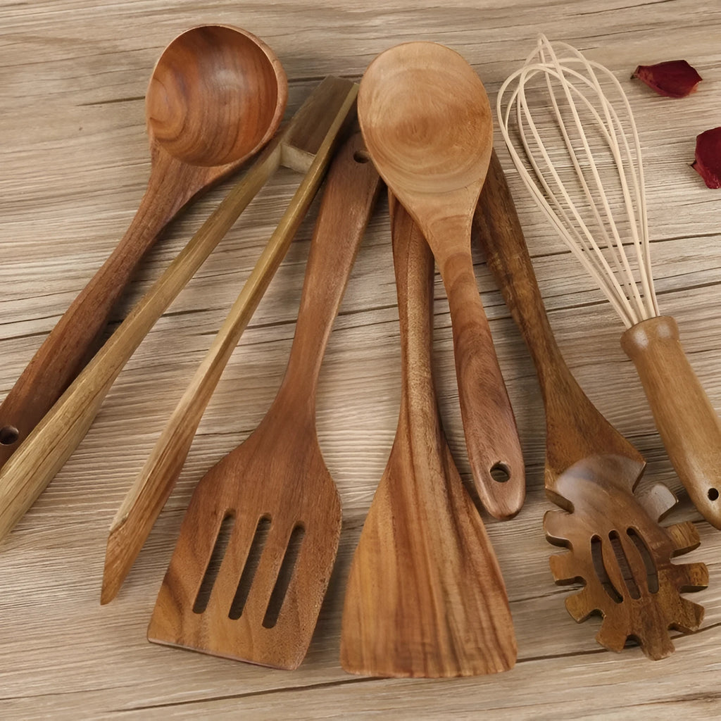A set of seven wooden cooking utensils including spoons and spatulas on a kitchen counter.