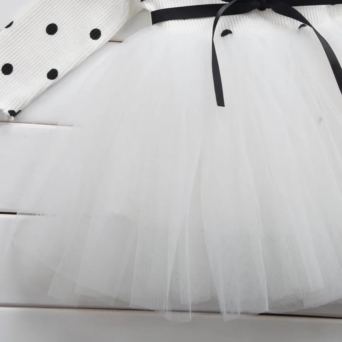 Baby girl wearing black lace tutu dress with long sleeves for birthday party