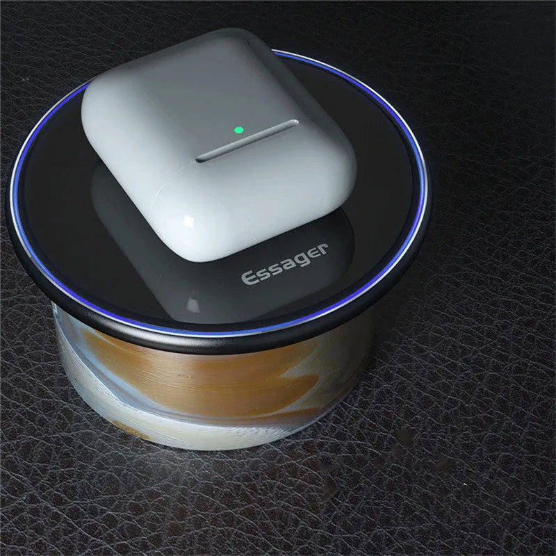 Black aluminium alloy Qi wireless fast charging pad for phones on a wooden desk.