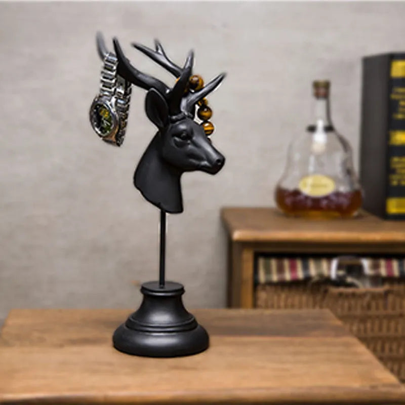 Tall black natural resin animal sculpture for home decoration on a wooden table.