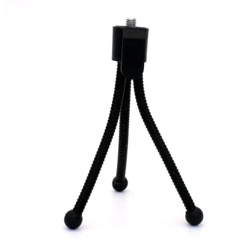 Small silver aluminium desktop tripod with ball head, shown collapsed next to an Apple iPhone for scale