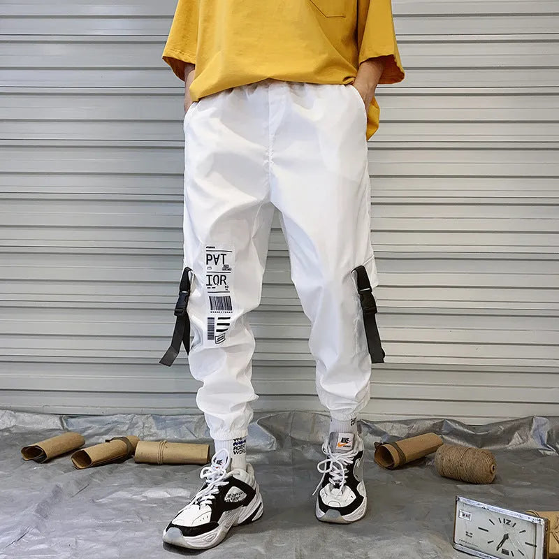 Men's hiphop trousers in black acetate fibre with tapered leg, side view