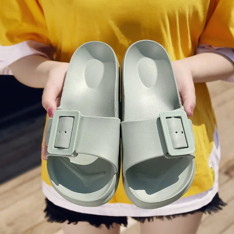 Women's grey blue flip flop slippers with a buckle strap and soft EVA sole.