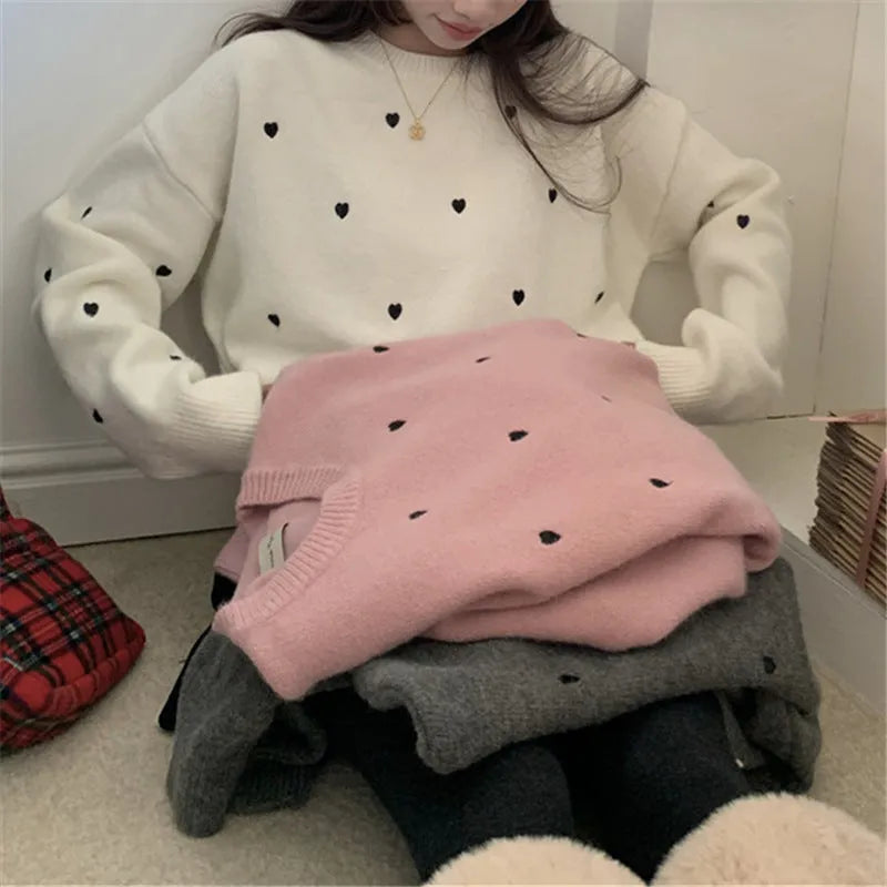 Women's loose grey acrylic pullover sweater with embroidery detail on the front, featuring long sleeves and a crew neck.