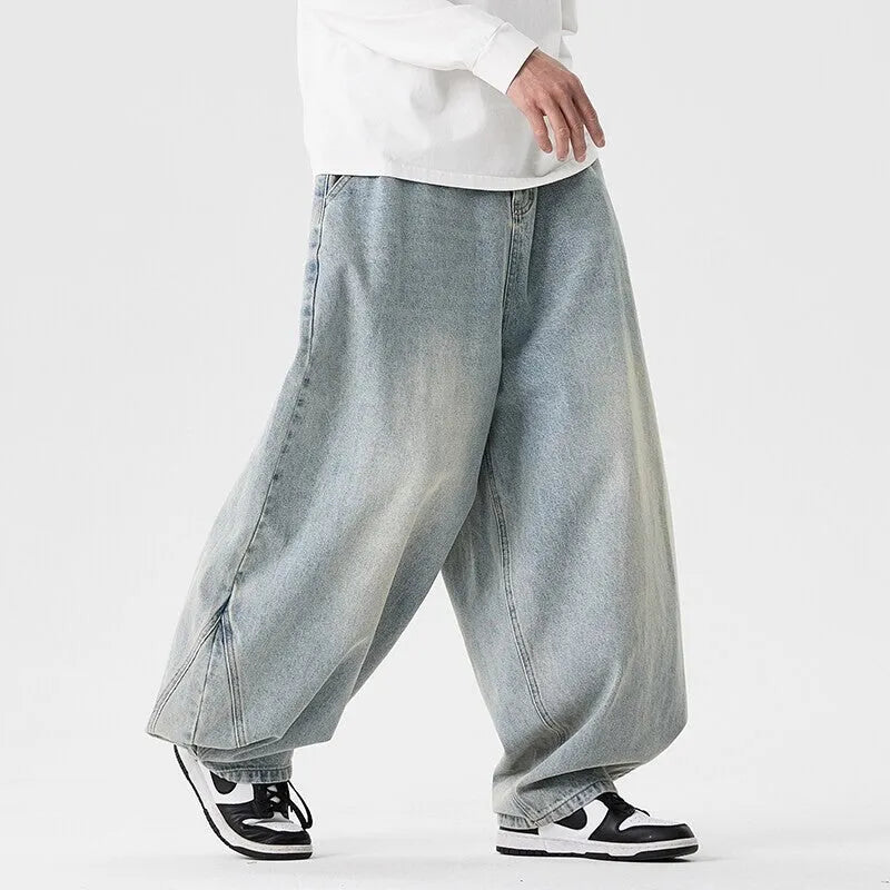 Men's plus-size baggy jeans in light blue denim with straight legs and low waist.