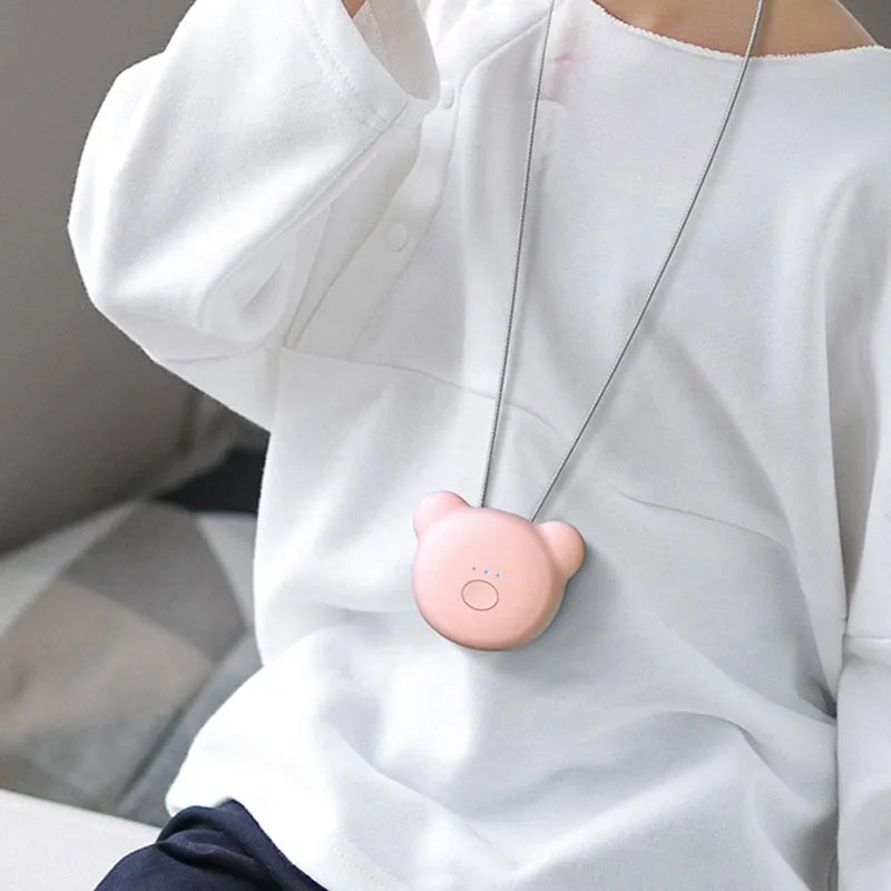 Mini USB air purifier necklace in pink showing compact wearable design with one-button control