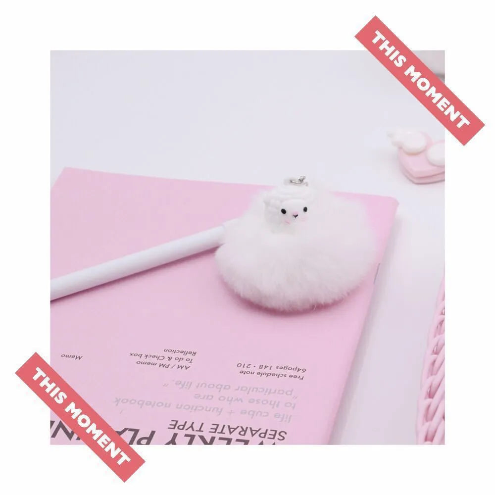 Alpaca hair ball pendant pen with 0.5mm tip and plastic barrel at 17cm length on a flat surface