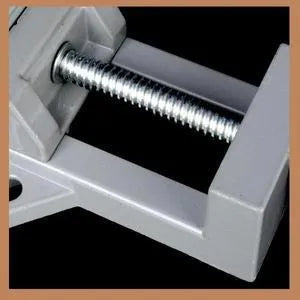 Black aluminium alloy 90 degree right angle clip with 70mm opening on a wooden workbench.