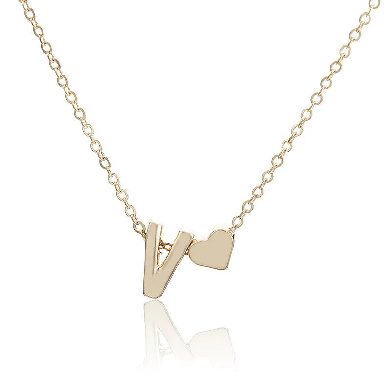 Peach heart shaped alloy pendant necklace charm in a gold colour finish on a model.