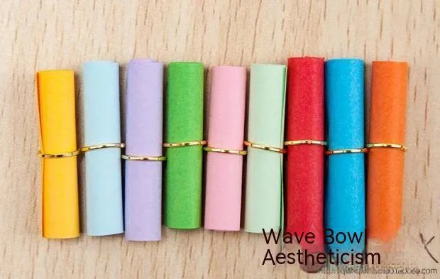 Colourful assortment of miniature rolled paper scrolls with metal eyelets for drift bottle messages.