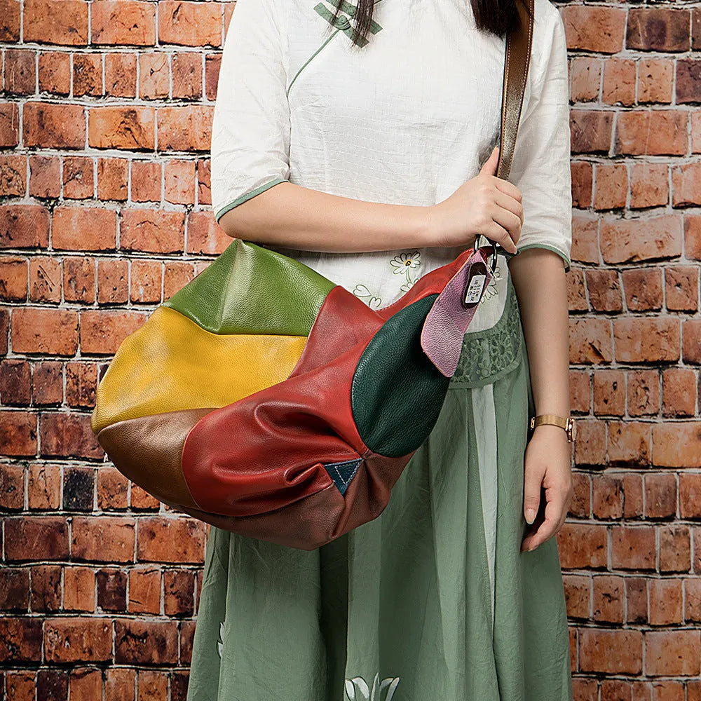 Cowhide leather crossbody travel bag in picture colour, shown with shoulder strap