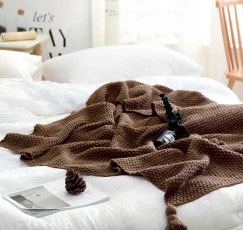 Nordic fringed knit ball acrylic blanket in beige colour showing texture detail and 130x170cm size