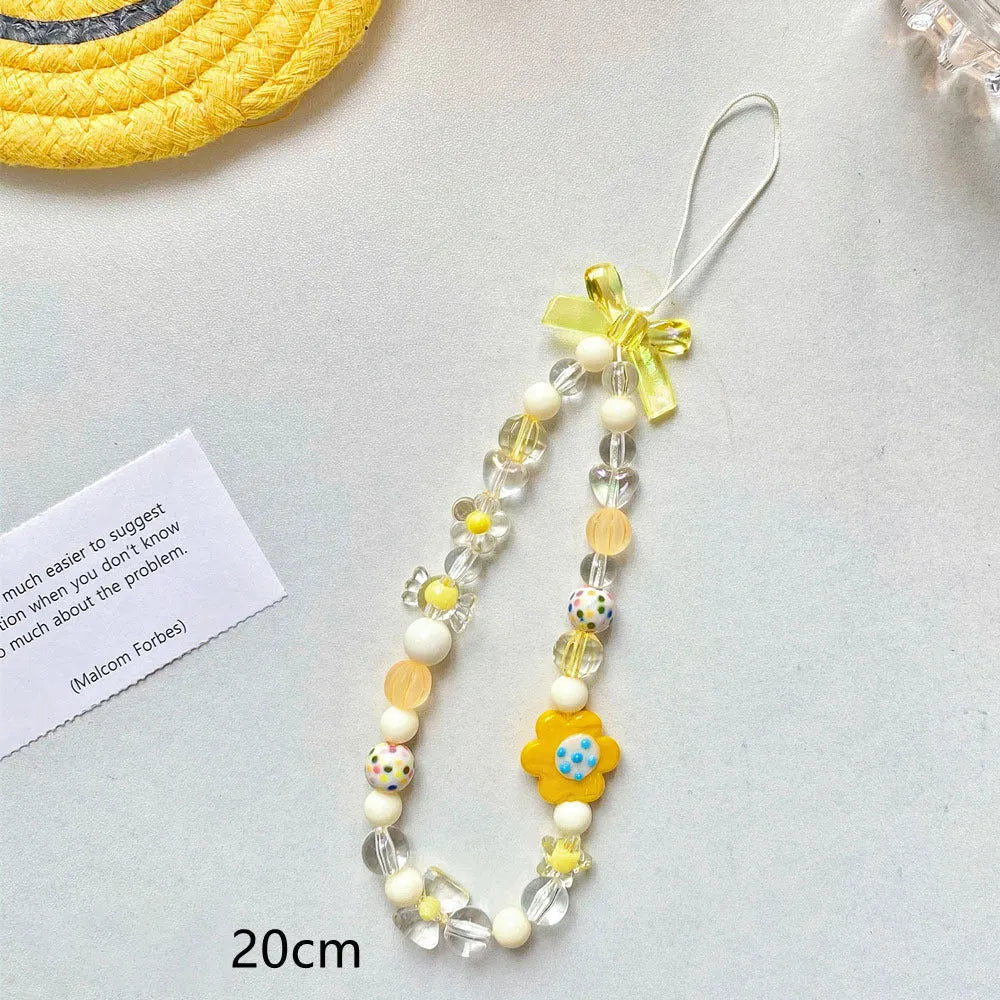 Beaded flower mobile phone lanyard with floral designs in yellow, blue, and pink colour options