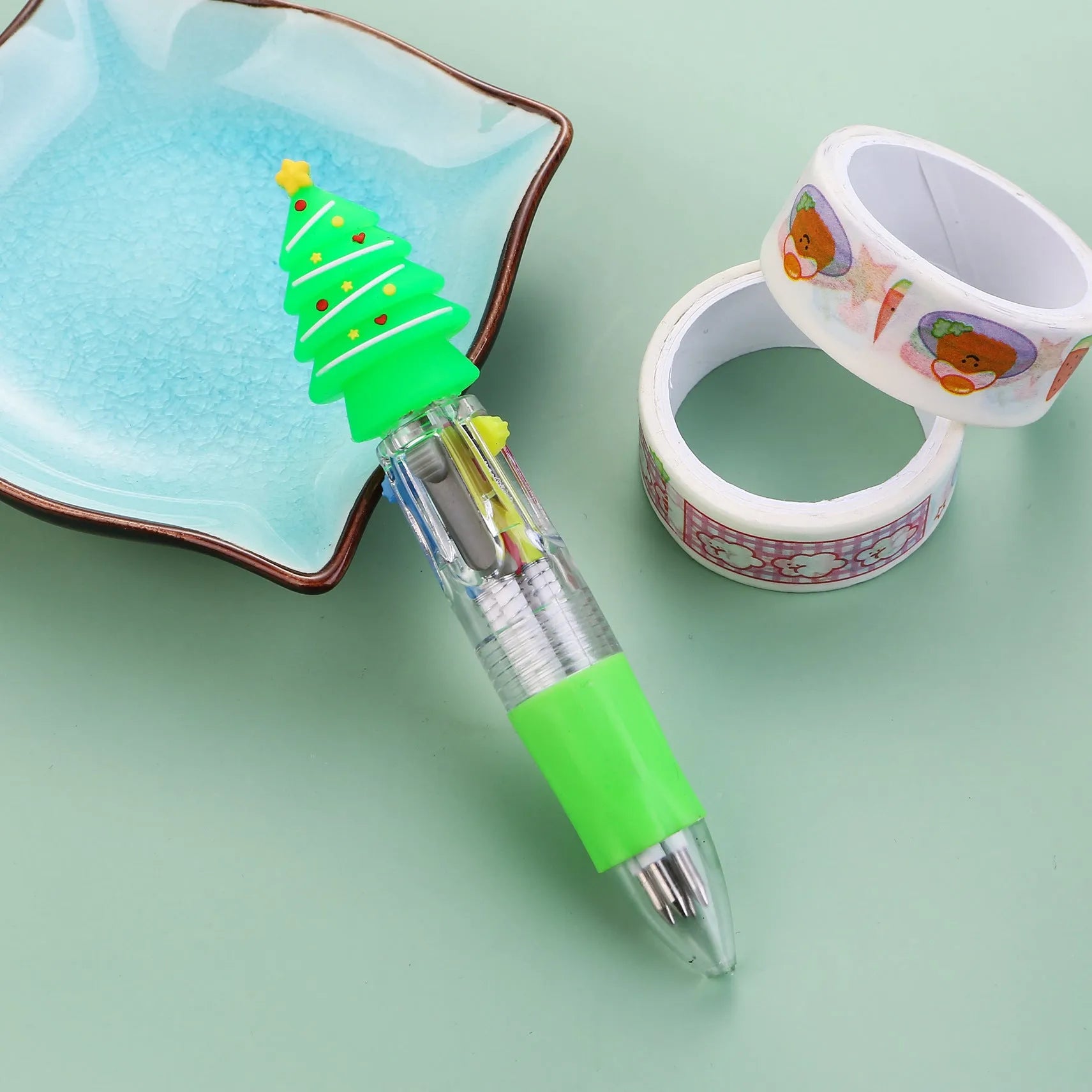 Compact 11cm Christmas four-colour press pen with festive designs including reindeer and snowmen.